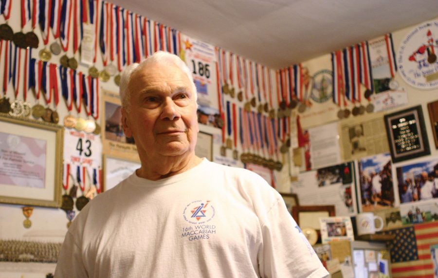 YEARS OF WINNING • Erich Dahl, 87, of Creve Coeur, will compete in track and swimming events during the Senior Olympics being hosted by the Jewish Community Center from May 25 through May 28. Dahl is pictured in a back room of his apartment, with a plethora of medals, press clippings, and mementos from previous competitions. Photo: Mike Sherwin