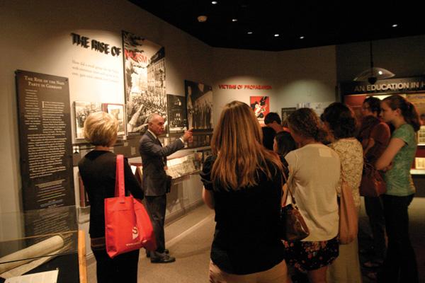 Holocaust+Museum+and+Learning+Center+docent+Buddy+Cooper+leads+a+group+of+students+through+the+museum+on+Friday.+Cooper+has+been+a+docent+for+the+past+four+years.+The+HMLC+is+celebrating+its+15th+anniversary+with+a+gala+event+May+16.+