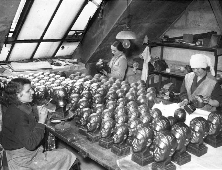 Women working on small busts of Adolf Hitler, 1937.