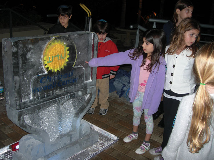 A+little+girl+points+to+a+menorah+made+of+ice+at+a+Boca+Raton+Hanukkah+party+that+attracted+some+200+Israelis+and+their+families+in+December.++Photo%3A+Sue+Fishkoff%2FJTA