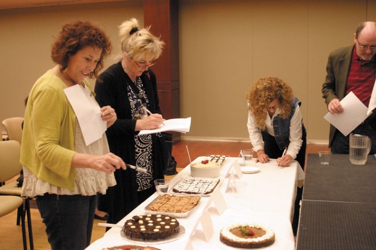 From left, Light Editor Ellen Futterman looks at the Passover dessert entries on Sunday at the Jewish Community Center, along with contest judges Robin Rickerman, director of food service and events manager at the JCC; Margi Lenga Kahn, food columnist for the Light; and Light Publisher/CEO Larry Levin. Photo: Mike Sherwin