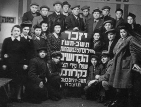 Elaine Alexander’s mother, Paula Zysling Kempinski, is shown at top right in this photo of Holocaust survivors from Klodawa, Poland. The image was taken in 1947 at the former Displaced Persons Camp in Landsberg, Germany. The sign  is translated as “Memorial, 1942 to 1947 to remember 350 Jewish families — martyrs — who fell at the hands of the Nazis in Klodawa,  5702 - 22 Tevet / Jan. 11, 1942.