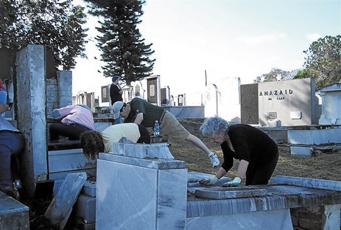 Twenty-five volunteers  from Congregation Shaare Emeth pull  weeds at the crumbling Ashkenazi Jewish Cemetery. 