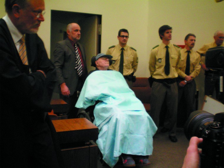 John Demjanjuk is wheeled into a Munich courtroom on Nov. 30, 2009 for the first day of his trial. The photo was taken by Sobibor death camp survivor Thomas Blatt.