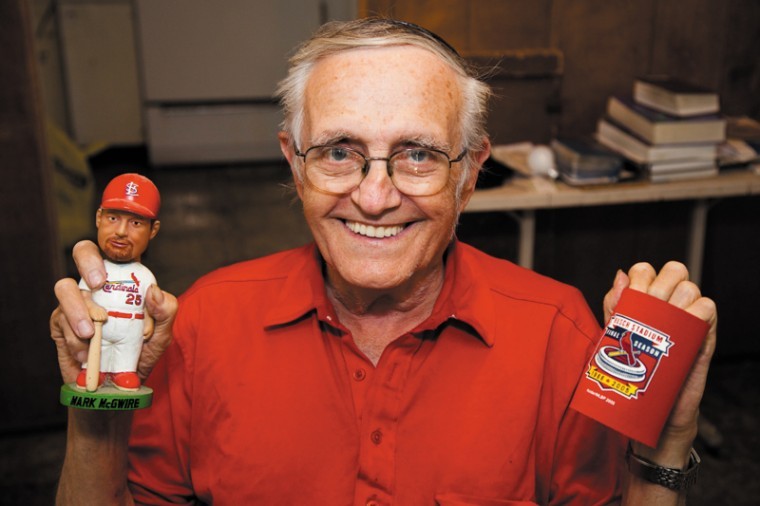 Howard Sandler shows a couple of the Cardinals items he has accumulated