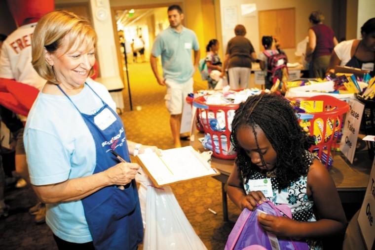 Merle Oberman helps Chloe fill her new backpack during National
Council of Jewish Womens Back to School! Store, held on Sunday at
Central Reform Congregation. For a gallery of images, visit
www.stljewishlight.com. Photo: Kristi Foster
