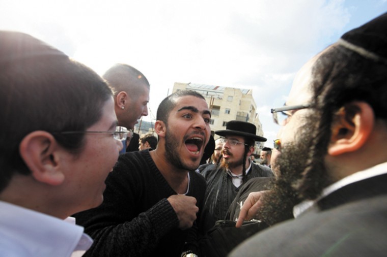 Haredi Orthodox men argue with secular Israelis in Beit Shemesh
following demands that authorities crack down on religious
extremists who want stricter gender segregation in the city, Dec.
26, 2011. Photo: Kobi Gideon / Flash90 / JTA
