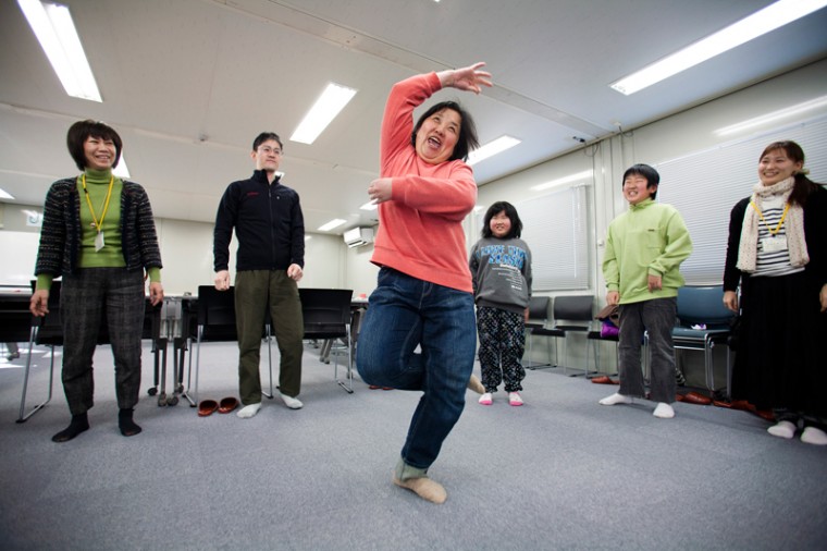 Residents of a temporary housing site for tsunami survivors in the city of Ishinomaki participating in a movement therapy session run by post-trauma experts from the Israeli NGO IsraAID.
