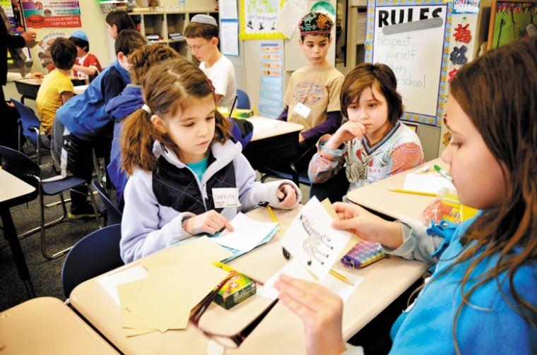 Third graders Daphne Levy, Alan Fulson and Aviva Kiernan work on
a project during the first joint event between students of the
former Solomon Schechter Day School of St. Louis and the Saul
Mirowitz Day School - Reform Jewish Academy. The schools have
merged to become the Saul Mirowitz Jewish Community School.
