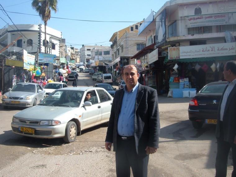 Zidan Badran, mayor of the Israeli portion of the Arab town of
Bartaa, stands on the seam that separates the Israeli part of town
from its West Bank portion.
