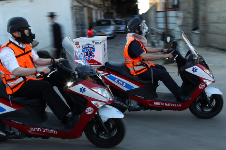 Haredi Orthodox volunteer paramedics wearing gas masks during a home-front drill in Jerusalem, June 23 2011.
