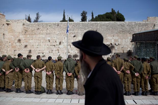 A+haredi+Orthodox+man+watching+Israeli+soldiers+at+an+army+ceremony+at+the+Western+Wall+in+Jerusalem%2C+Feb.+22%2C+2012.%0A