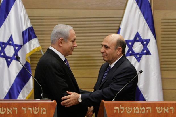 Israeli Prime Minister Benjamin Netanyahu, left, and Kadima Party chairman Shaul Mofaz at a joint news conference in the Knesset announcing that Kadima has joined the coalition government, May 8, 2012.
