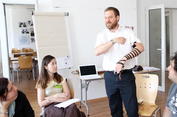 Rabbi Josh Ahrens demonstrating how to put on tefillin during a conversion course at the Sofia JCC in Bulgaria, May 6, 2012.
