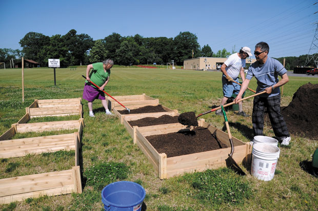 From left Linda Kram, Alan Rosenthal and Zhiwei Zhao preparing the garden beds for ‘Garden of Eden’ at the Jewish Community Center. 
