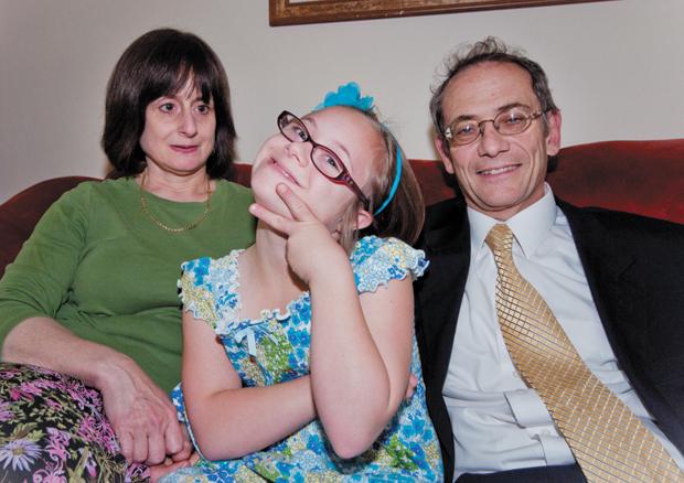 Yelli (center) strikes a pose next to her parents, Chani and Rabbi Ze’ev Smason. Yelli is 11 years old and has Down syndrome. 
