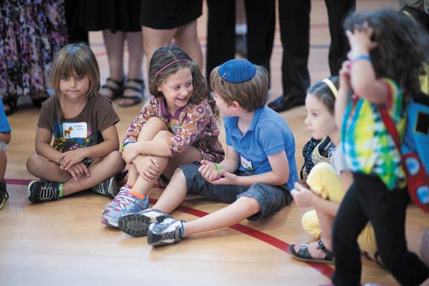 (From left) Zahava Kiernan, Riva Stern and Daniel Shanker sit in the Saul Mirowitz Jewish Community School gymnasium before Simchat Gan, a ceremony marking the first day of school for kindergarten students. Photos: Yana Hotter
