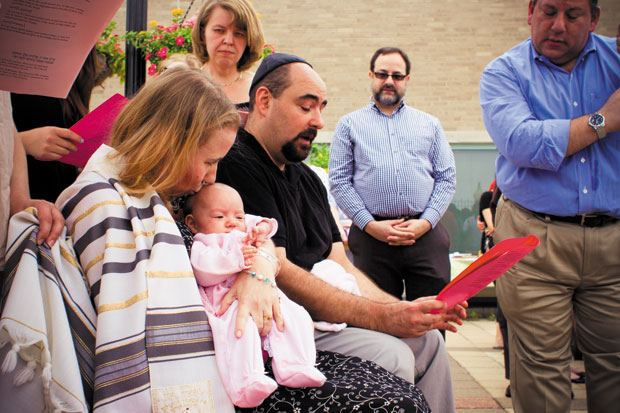 Lisa and Thomas Klein are shown at the baby-naming ceremony for their daughter, Annie. A couple of months after the baby was born, Lisa was diagnosed with an aggressive form of cancer. Photo courtesy the Klein family
