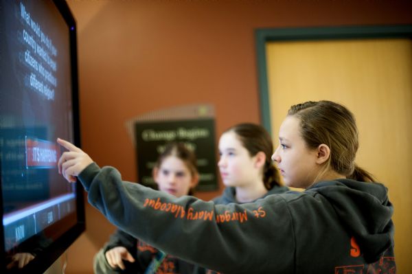 Madison Reynolds, Savannah Viragh and Kayla Brown, middle school students from St. Mary Margaret Alacoque check out the Holocaust Museum and Learning Centers new, interactive exhibit on its opening day. Photo: Yana Hotter
