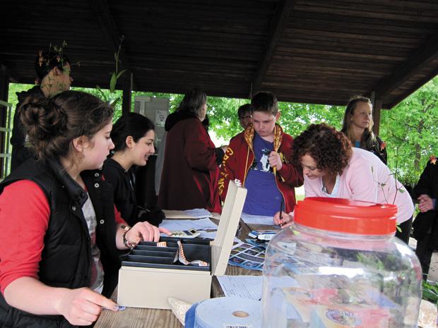 Jewish Environmental Initiative teen group members Shira Feen and Shira Siegel check customers out at the 2012 JEI Teen Group Native Plant Sale and Rain Barrel Raffle
