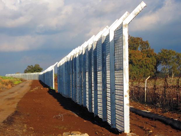 Israel started construction on the new fence separating the Golan Heights from Syria, seen in front of the old one, in response to possible consequences from the Syrian civil war.
