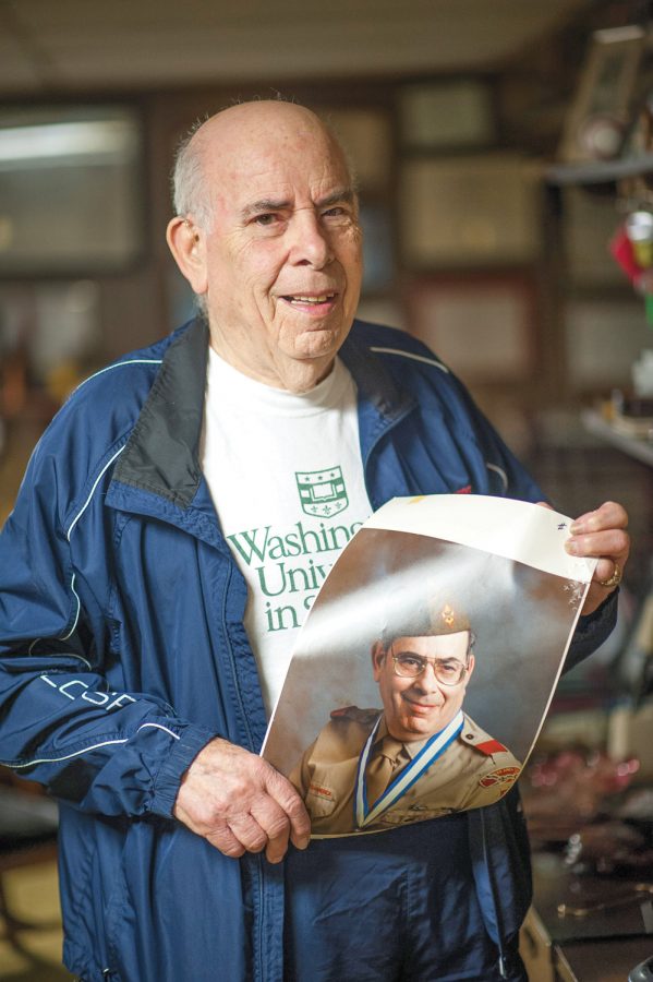 Sandy Silverstein displays a photo of himself in his scoutmaster uniform, at his home in Olivette. Photo: Yana Hotter