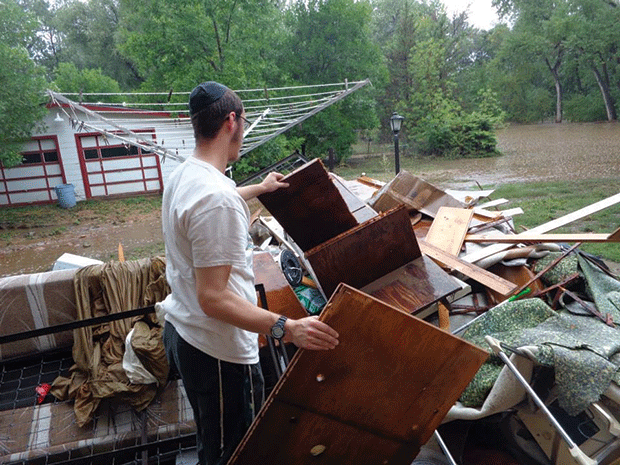 A+Chabad+volunteer+helps+people+clear+damaged+goods+from+their+homes+in+Colorado.+Photo%3A+Courtesy+of+Chabad%2FJTA%C2%A0