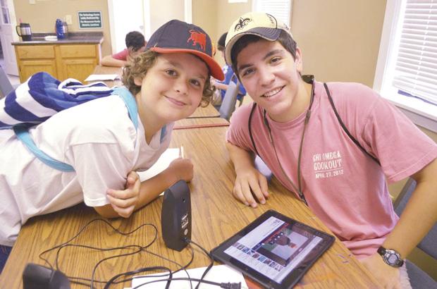 Two boys show off what Six Points Sci-Tech Academy will have to offer this summer: robotics and engineering, video game design, environmental science,  and digital media production. (photo courtesy of Six Points Sci-Tech Academy) 