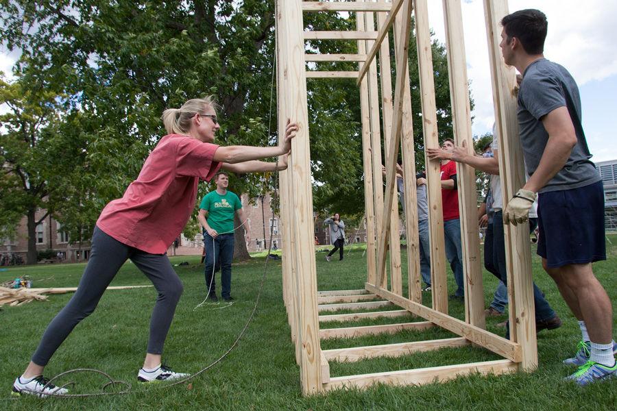 University of Louisiana at Lafayette professor Ashlie Latiolais gets help from her team and the Kansas State team in raising the 14-foot structure of Latiolais sukkah design on Oct. 6, 2014 at Washington University. Latiolais design was one of 10 finalists in Sukkah City STL, held by St. Louis Hillel and Wash U. The teams constructed their sukkot on the quadrangle just west of the universitys Olin Library.