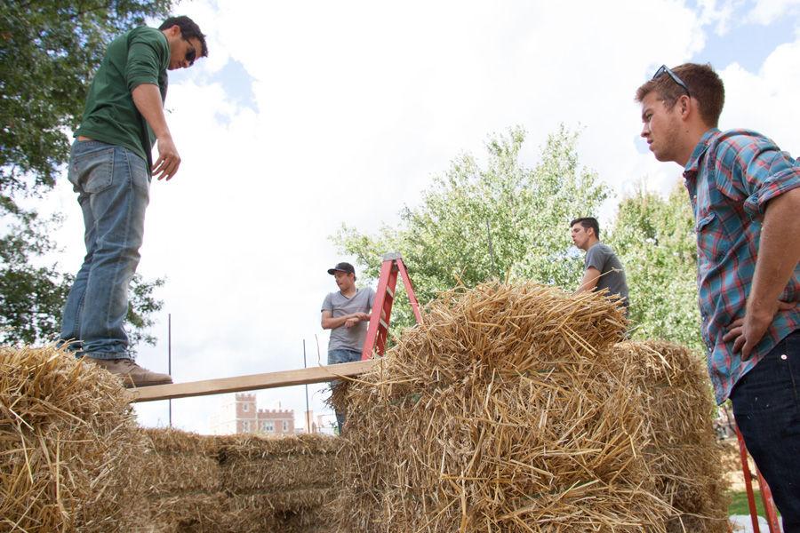 Kansas State architecture students (from right) Brian Delaney, Brandon Eversgerd and Eric Dernbach work on constructing fellow student Devin Browns sukkah design on Oct. 6, 2014 at Washington University. Browns design, made of hay bales, was one of 10 finalists in Sukkah City STL, held by St. Louis Hillel and Wash U. The teams constructed their sukkot on the quadrangle just west of the universitys Olin Library.