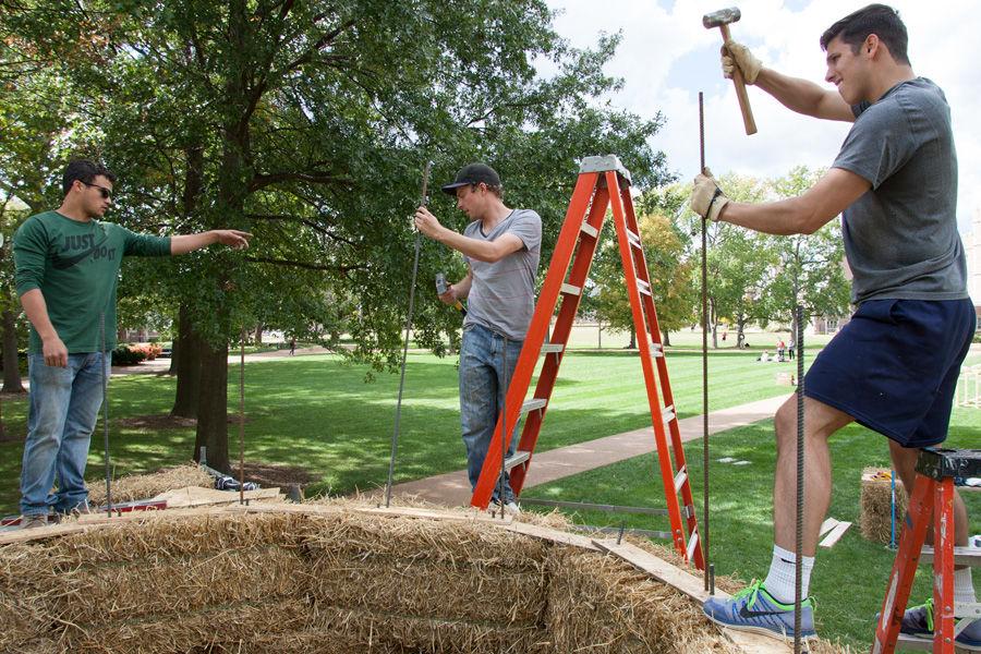 Kansas State architecture students (from right) Brandon Eversgerd and Eric Dernbach work on constructing fellow student Devin Browns sukkah design on Oct. 6, 2014 at Washington University. Browns design, made of hay bales, was one of 10 finalists in Sukkah City STL, held by St. Louis Hillel and Wash U. The teams constructed their sukkot on the quadrangle just west of the universitys Olin Library.