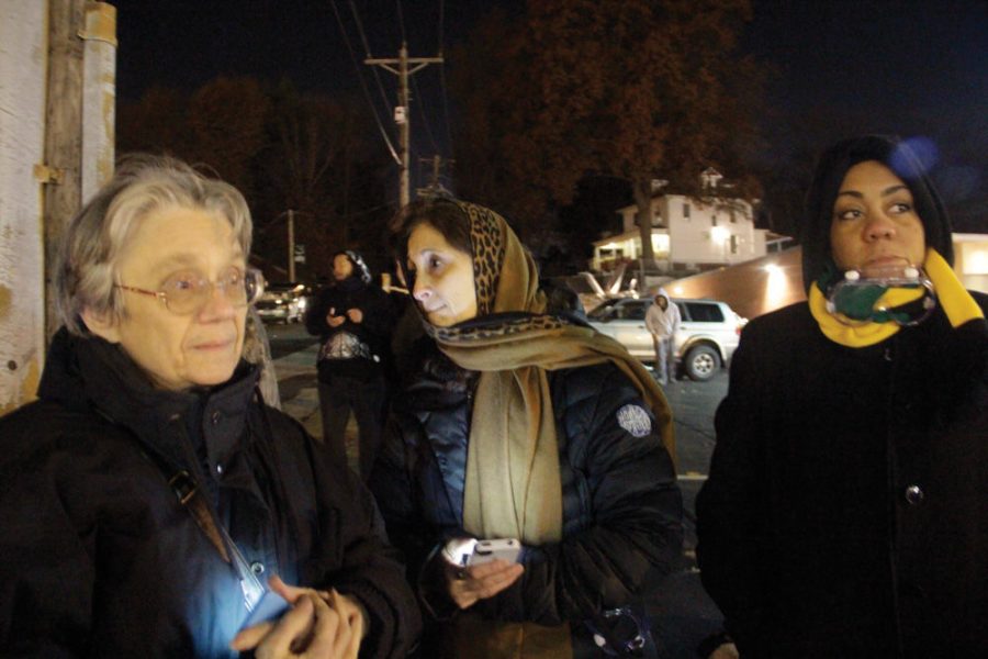 From left, Margaret Phillips, Rabbi Susan Talve and Rev. Melissa Bennett, stand across from the Ferguson police station Monday night, about an hour after tear gas had been released to disperse protesters. Photo: Philip Deitch 