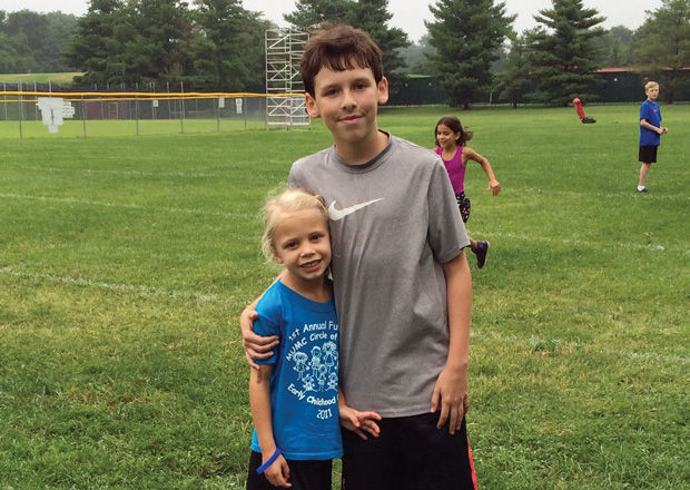 Jacob Stone and his cousin Eva (above) at the kickball fundraiser Jacob organized to benefit the Dystonia Medical Research Foundation.  