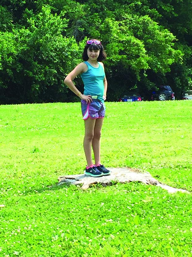 Lily Hoberman stands in the spot at Camp GUCI where she was injured in 2013 by a lightning strike.  Two others were also hurt.