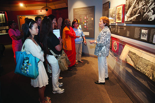 Last week, longtime Holocaust Museum and Learning Center docent Sarijane Freiman  (right) leads a museum tour for a group studying English as a Second Language in the Parkway Area Adult Education and Literacy program. Photo: Andrew Kerman