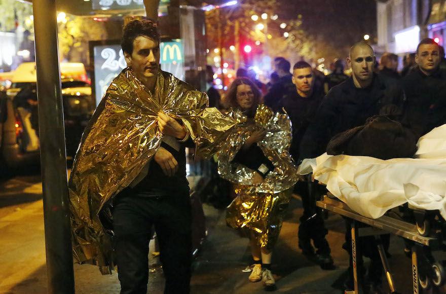 Victims+walk+away+outside+the+Bataclan+theater+in+Paris%2C+Friday+Nov.+13%2C+2015.+Well+over+100+people+were+killed+in+a+series+of+shooting+and+explosions+explosions.+French+President+Francois+Hollande+declared+a+state+of+emergency+and+announced+that+he+was+closing+the+countrys+borders.+%28AP+Photo%2FJerome+Delay%29
