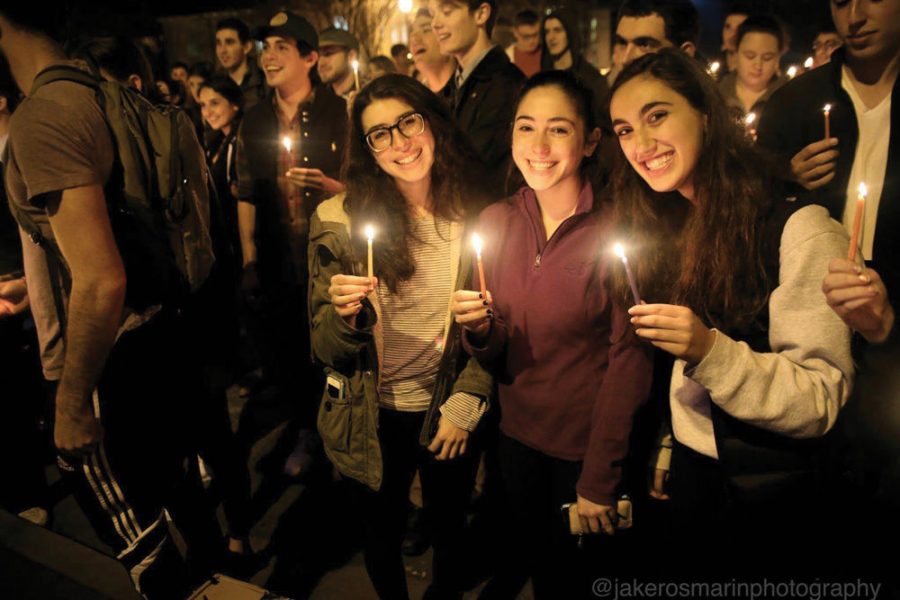 University freshman Kate Rubin holds candles with her friends from Hillel during a Hanukkah celebration.