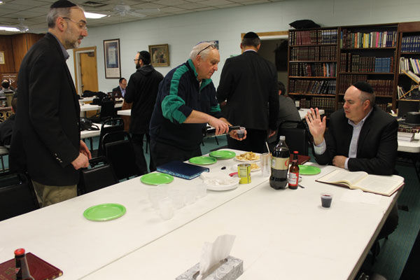 Reuven Kenigsberg (center) prepares to learn Torah with other students on Feb. 24 at the Chesterfield Kollel at Tpheris Israel Chevra Kadisha Congregation. Photo: Eric Berger