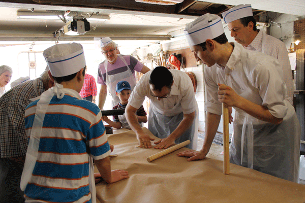 Rabbi Shaya Mintz rolls the matzah dough