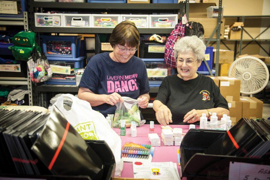 Ann Frank (right) and Charlene Schweitzer collect items to pack at Project Backpack in late April. Photo: Andrew Kerman