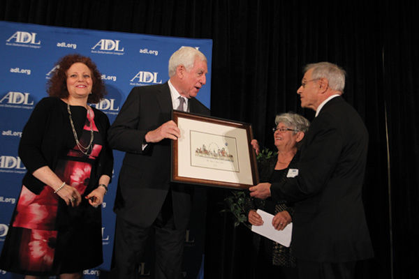 Former Sen. John Danforth (second from left) receives an illustration of the St. Louis skyline from Ann and Harvey Tettlebaum during the Anti-Defamation League’s Torch of Liberty Award Luncheon June 1.  At left is ADL Regional Director Karen Aroesty. 