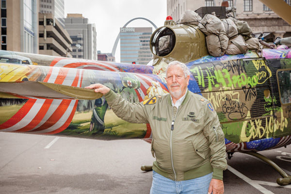 Eric Berla stands with the medevac helicopter he flew during the Vietnam War — now transformed into a artistic display. The helicopter is on display through Sunday at the Soldiers Memorial Military Museum downtown. Photo: Kristi Foster