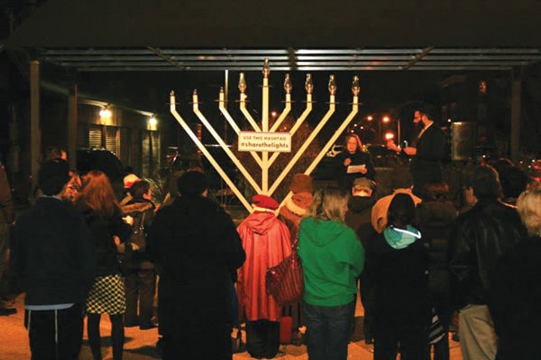 Rabbi Novack of Chabad is joined by University City Council member Paulette Carr at the public Menorah lighting on the Delmar Loop in a previous year.