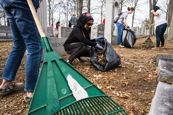 Volunteers+rake+leaves+and+remove+debris+at+Chesed+Shel+Emeth+Cemetery+during+a+cleanup+event+Feb.+22+which+drew+more+than+2%2C500+people+hoping+to+help+after+154+headstones+were+overturned+at+the+cemetery.+Photos%3A+James+Griesedieck