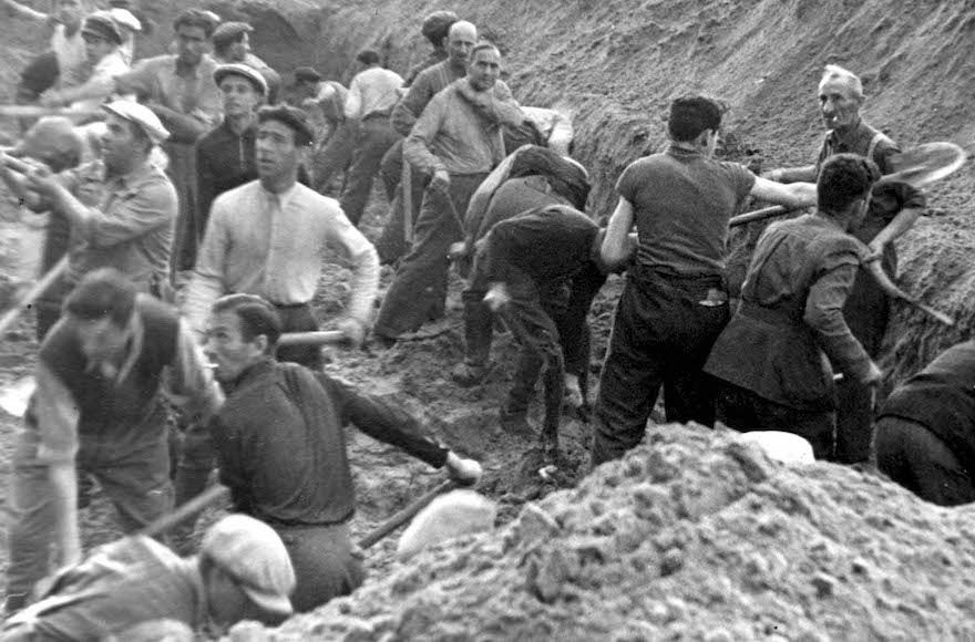 Jews digging a trench in which they were later buried, after being shot, in Ponary, Poland. (Courtesy of Yad Vashem)