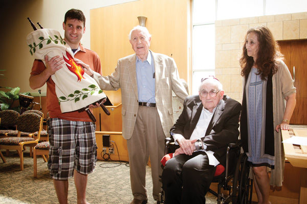 From left, Sam Weigley, Arthur Litz, Sylvan Robinson, and Rabbi Susan Talve take part in a ceremony May 19 at Central Reform Congregation finalizing the gifting of a Holocaust Torah to CRC from Kol Katan, a longtime St. Louis chavurah/congregation. Robinson and Litz were past presidents and longtime members  of Kol Katan. For more photos from the ceremony, visit stljewishlight.com/multimedia.Photo: Andrew Kerman