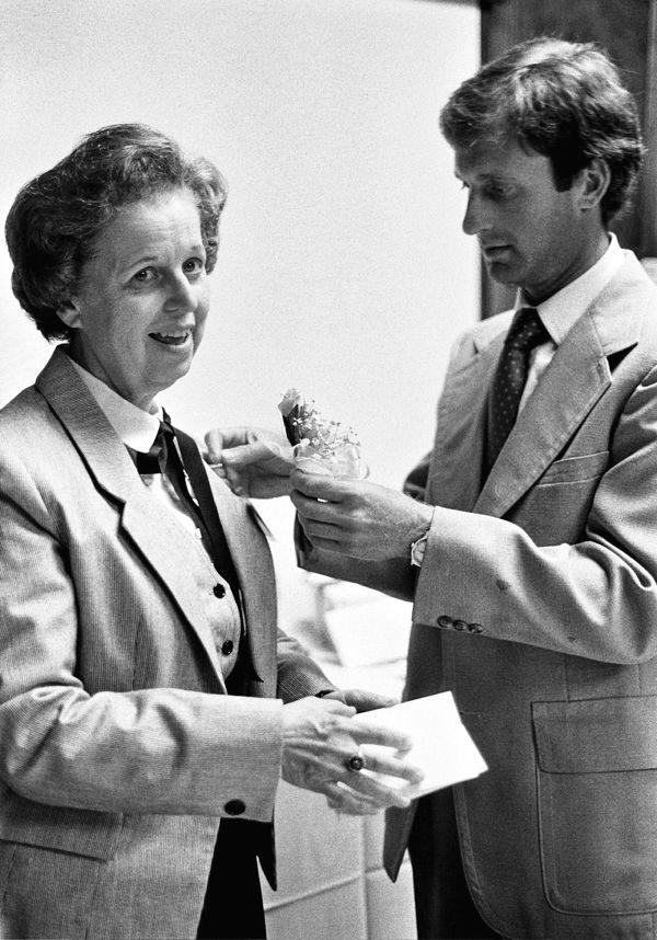 Bill Motchan pins a corsage on the lapel of his mother, Lydia Motchan, at her retirement party from Jewish Hospital on July 28, 1983.