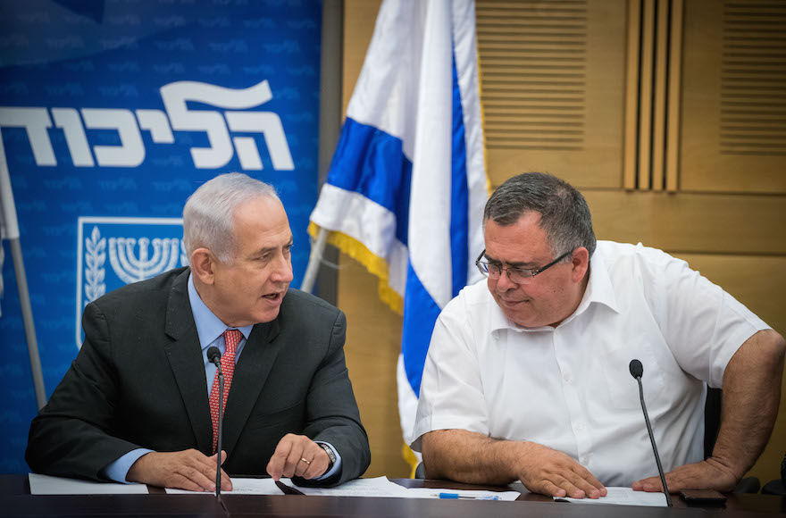 Israeli Prime Minister Benjamin Netanyahu, left, with Knesset member David Bitan at a Likud party meeting at the parliament in Jerusalem, June 12, 2017. (Yonatan Sindel/Flash90)