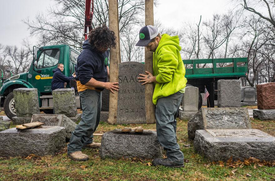 Workers placing headstones back on their bases at Chesed Shel Emeth Cemetery in the St. Louis area. Photo: James Griesedieck/St. Louis Jewish Light