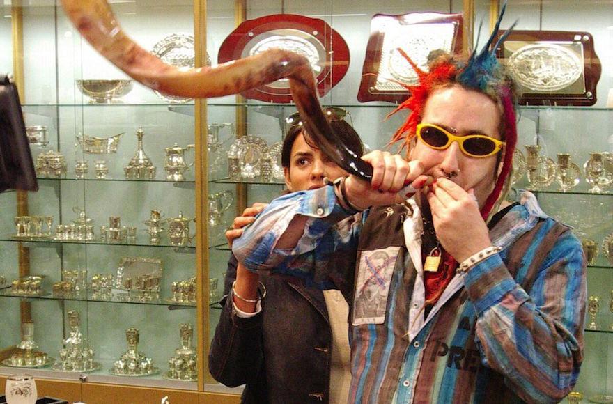 Bram Presser of the band Yidcore blowing a shofar at a Judaica store in Melbourne, Australia. (Peter Haskin)